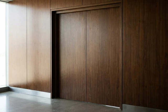 A discreet luxury business environment featuring closed boardroom doors and elegant minimalist architecture